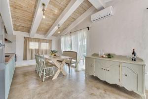 a kitchen with a table and a dining room at JARDIN de VILLE in Lithakia