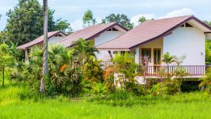 a house in the middle of a field at Pimali Resort & Training Centre in Nong Khai