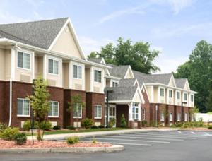 a row of houses with a parking lot at Microtel Inn & Suites Chili/Rochester in Chili Center