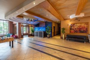 a large living room with a large aquarium at Hotel Badura in Wadowice