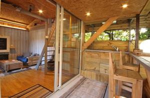 an inside view of a large wooden house with a living room at Les Insolites de Coco in La Lande-de-Goult