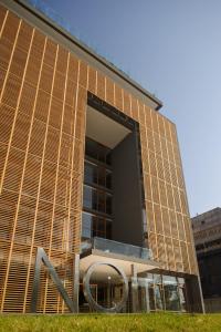 a building with a sign in front of it at NOI Vitacura in Santiago