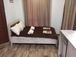 a bedroom with a bed with two teddy bears on it at Cottage Euro Style in Ureki