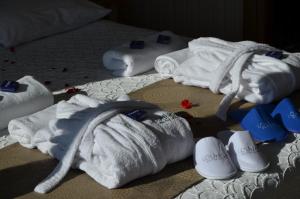 a group of towels andippers on a bed at Lounge Hotel in Tuzla