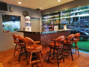 a bar with wooden stools in a restaurant at Hotel Sunjoy9 @ Mid Valley in Kuala Lumpur