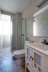a bathroom with a toilet and a sink and a shower at Apartamento La Terraza del Mar in Cádiz