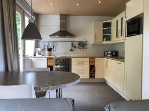 a kitchen with a table and a counter top at Villa des Grues à Filly in Houffalize