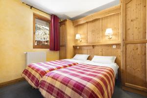 Postel nebo postele na pokoji v ubytování Résidence Les Balcons de Val Cenis Village