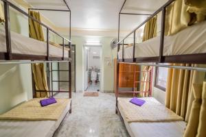 two bunk beds in a room with a hallway at Linh's Homestay in Phong Nha