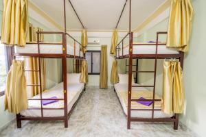 a bedroom with three bunk beds in a room at Linh's Homestay in Phong Nha