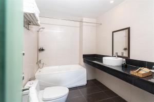 a bathroom with a white toilet and a sink at Jazz Hotel in Danang