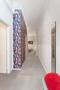 a hallway with a wall of ceramic tiles at HouSmart Bondi 61 in Bologna