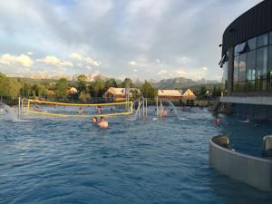 a swimming pool with people in the water at Willa Anna in Kościelisko