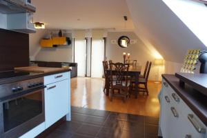 a kitchen and living room with a table and chairs at FeWo LaChristina Köln-Bonn-Siegburg in Troisdorf