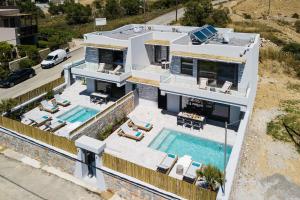 an aerial view of a house with a swimming pool at Naiades Apartment- Minthi/ 1 bedroom, beachfront in Plakias