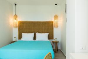 a bedroom with a blue bed with two pillows at Naiades Apartment- Minthi/ 1 bedroom, beachfront in Plakias