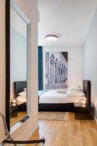 a bedroom with a bed and a large mirror at Luxury rooms Paula in Split