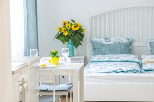 een slaapkamer met een bed en een tafel met een vaas met bloemen bij Harrison(e) in Boedapest