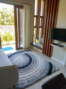 a room with a rug on the floor in front of a door at The Villa's Kubu Sandan in Kintamani