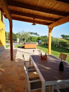 a table and chairs under a pavilion on a patio at Montenovo Country House in Ostra Vetere