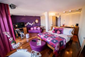 A bed or beds in a room at Bohemia Suites & Spa - Adults Only
