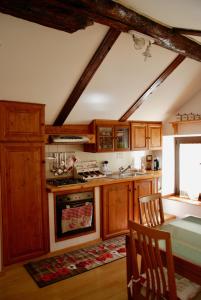 a kitchen with wooden cabinets and a stove top oven at CasAda in Nus