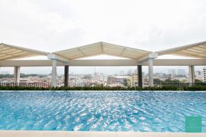 a swimming pool on the roof of a building at JOMSTAY Octagon Ipoh Suites in Ipoh