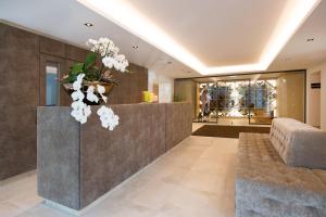 a lobby with a reception desk with a vase of flowers at Minglers Sportalm - Das Gourmet- und Genießerhotel in Kirchberg in Tirol +103 photos