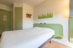 Postel nebo postele na pokoji v ubytování Hotel Ibis Budget Vichy