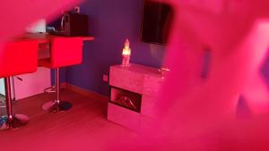 a living room with a red room with a fireplace at Lov'appart in Boulogne-sur-Mer