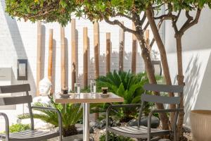 a table and chairs in a garden with trees at Kyriad Montpellier Sud - Lattes in Montpellier +53 photos