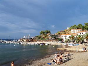 a group of people on a beach near the water at Appartement de charme à 50m de la plage de sable in Collioure