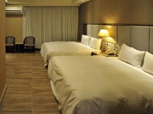 מיטה או מיטות בחדר ב-Maple Hotel Second Branch