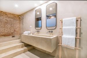 a bathroom with a large sink and a bath tub at Casa Lirio in Barcelona