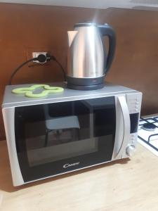 a microwave with a coffee pot on top of it at B&B SICILIA in Messina +15 photos