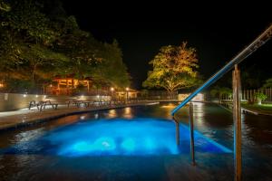 a swimming pool in a park at night at Samadhi Ecohotel by Rotamundos in Puerto Escondido