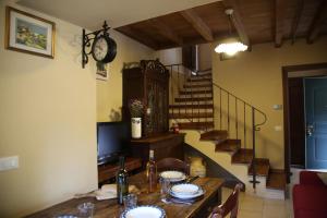 a dining room with a table and a staircase at A Cà Du Barbijun in Pieve di Teco