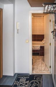 a bathroom with a shower and a tub at Vilnius Centre Flat in Vilnius