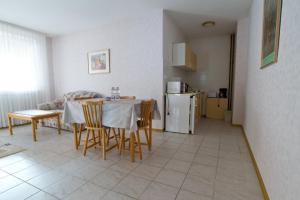 a kitchen and dining room with a table and chairs at Csokoládé in Hévíz