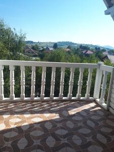 a white railing on a balcony with a view at Vila Tom Cris in Câmpina