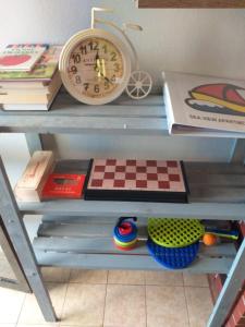 a clock sitting on top of a table with books at Apartment Marko in Crveni Vrh