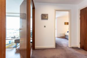 a hallway with a door leading to a room at Esquire Media City in Manchester