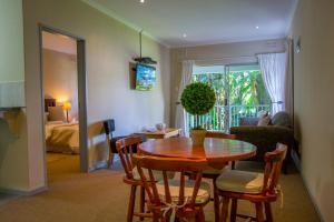a living room with a wooden table and chairs at Dunranch House in Pietermaritzburg