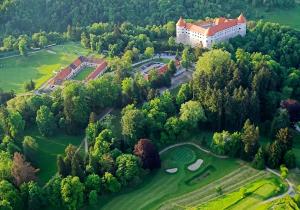 an aerial view of a castle on a golf course at Rooms under the sun in Brežice