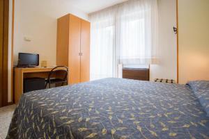 Postel nebo postele na pokoji v ubytování Hotel Benacus