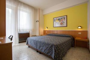 Postel nebo postele na pokoji v ubytování Hotel Benacus