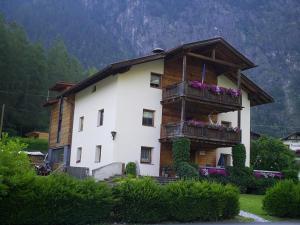 a large house with balconies and flowers on it at Haus Gstrein in Oetz