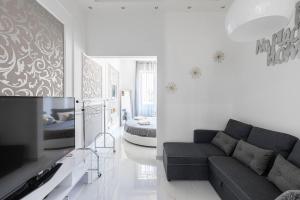 a living room with a couch and a bed at Sea Elegance in Oliveri