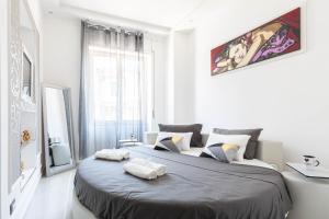 a bedroom with a large bed with two towels on it at Sea Elegance in Oliveri