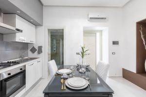 a kitchen with a table with plates on it at Sea Elegance in Oliveri